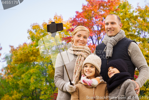 Image of family taking selfie over autumn park background