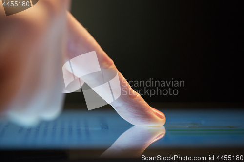 Image of close up of hand using computer touch screen