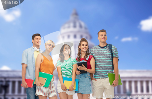 Image of students with books over american white house