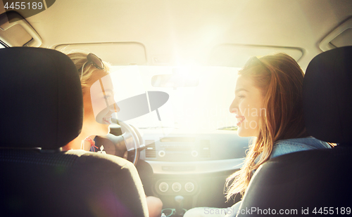 Image of happy teenage girls or women in car at seaside