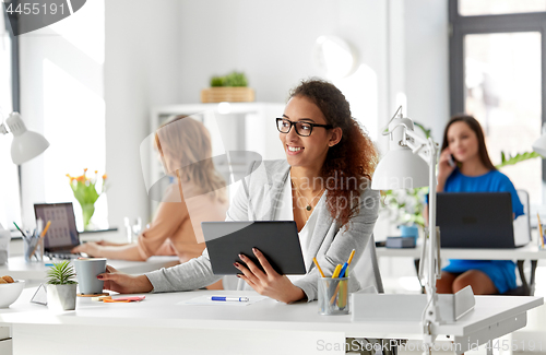 Image of businesswoman with tablet pc and coffee at office