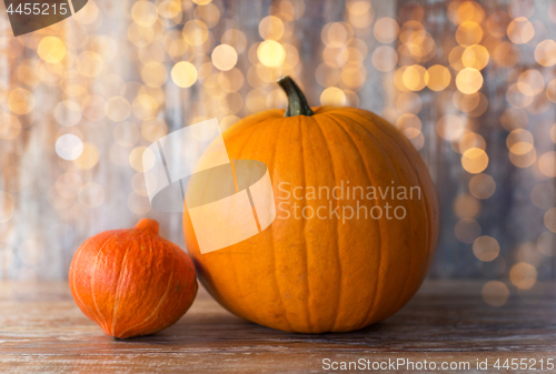 Image of pumpkin and red kuri squash on wooden background