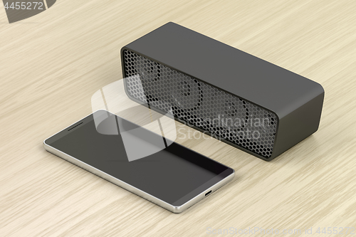 Image of Black smartphone and bluetooth speaker