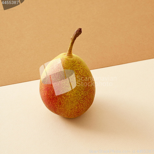 Image of pear on colored paper background