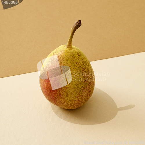 Image of fresh pear on colored paper background