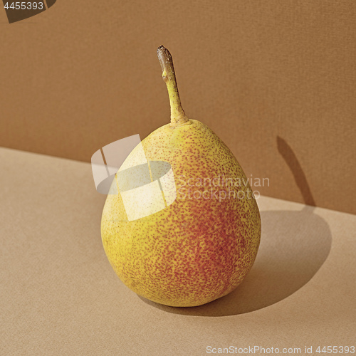 Image of pear with long shadow