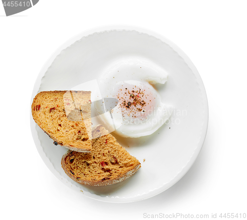 Image of poached egg on white plate