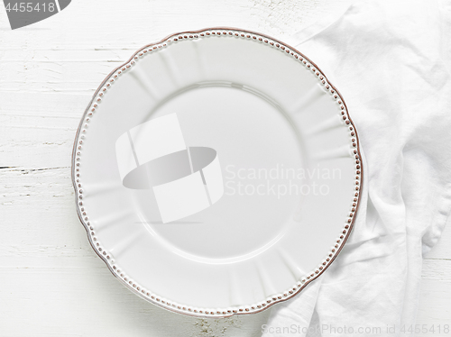 Image of white plate on wooden table