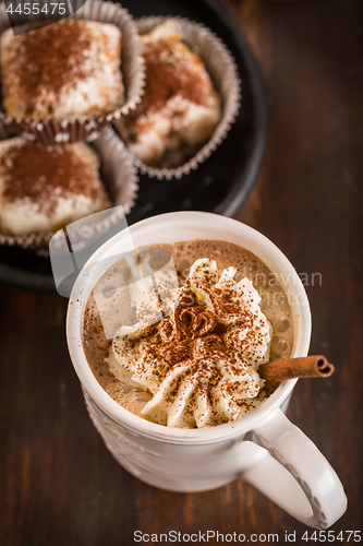 Image of Christmas hot chocolate with whipped cream and cookies