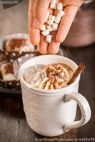 Image of Christmas hot chocolate with whipped cream and cookies