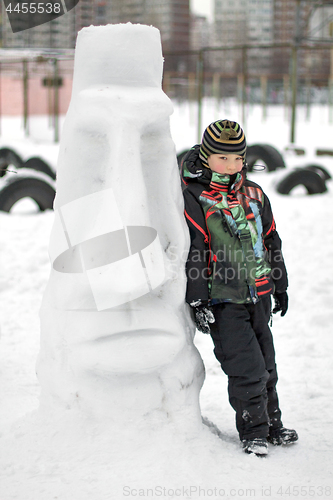 Image of Boy making a winter snowman