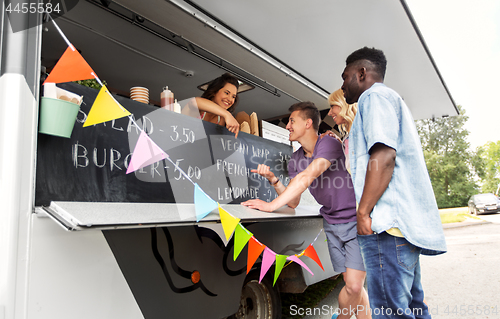 Image of customers or friends and saleswoman at food truck