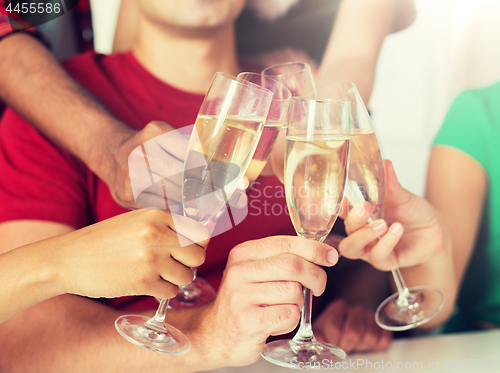 Image of friends clinking glasses of champagne at party