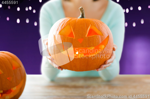 Image of close up of woman with halloween pumpkin