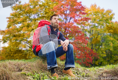 Image of man with backpack hiking in autumn