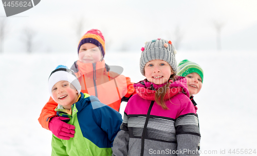 Image of happy little kids in winter clothes outdoors