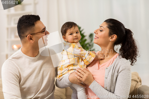 Image of happy family with baby daughter at home