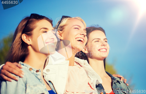 Image of happy women or teenage girls hugging outdoors