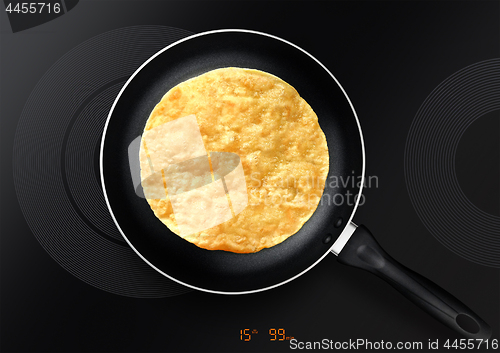 Image of black frying pan with pancake