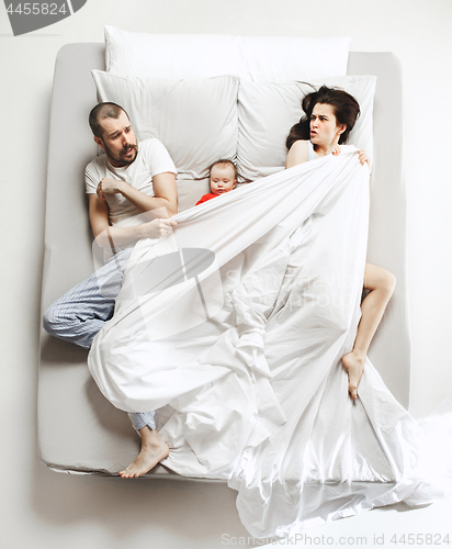 Image of Top view of happy family with one newborn child in bedroom.