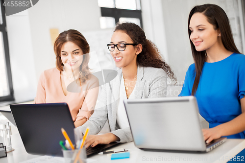 Image of businesswomen with laptop working at office