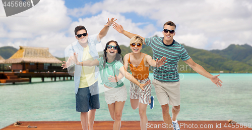 Image of friends in sunglasses having fun over bora bora