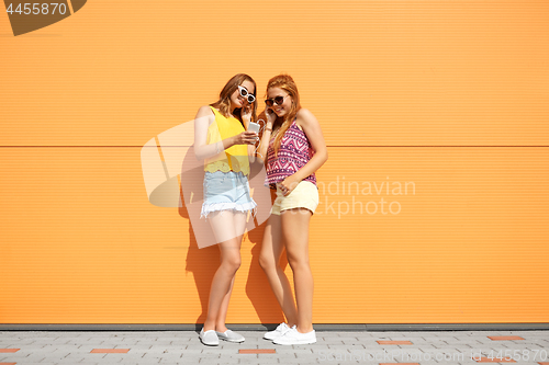 Image of teenage girls listening to music from smartphone