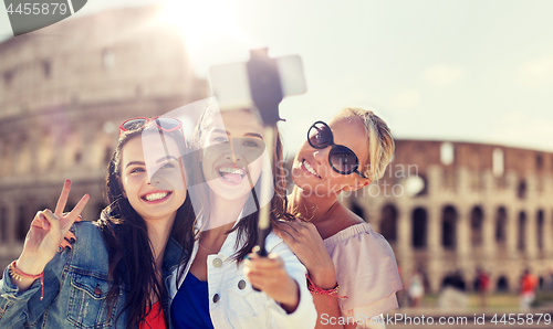 Image of group of smiling women taking selfie in rome