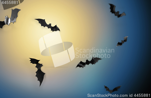 Image of bats flying over moonlight in night sky background