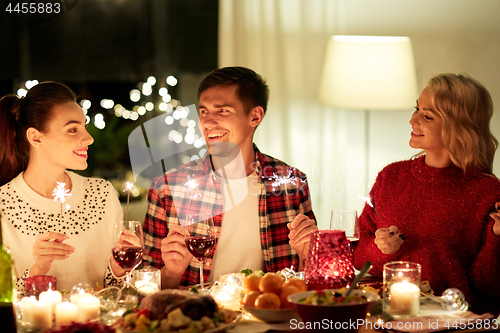 Image of happy friends celebrating christmas at home feast