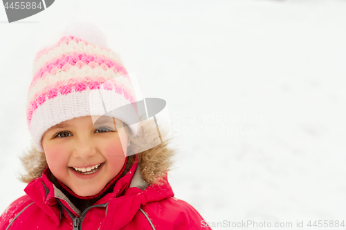 Image of happy little girl in winter clothes outdoors