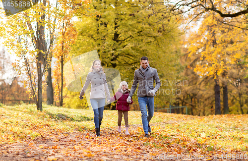 Image of happy family walking at autumn park