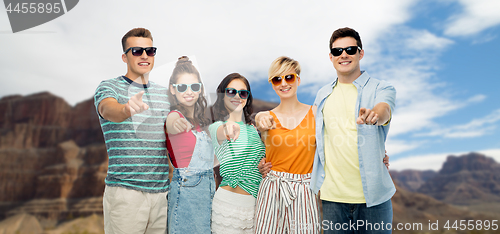 Image of friends pointing at you over grand canyon