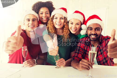 Image of happy team celebrating christmas at office party