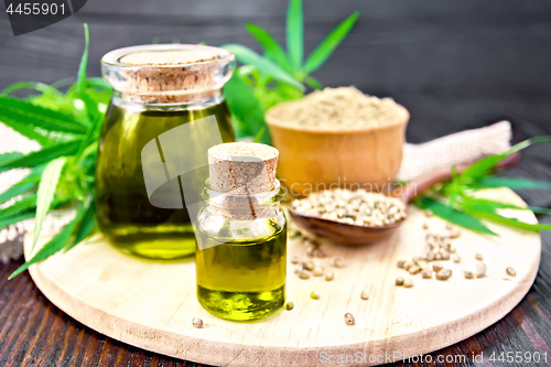 Image of Oil hemp in two jars with flour on board