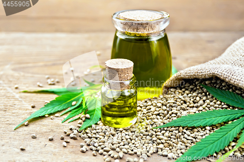 Image of Oil hemp in two jars with grain on board