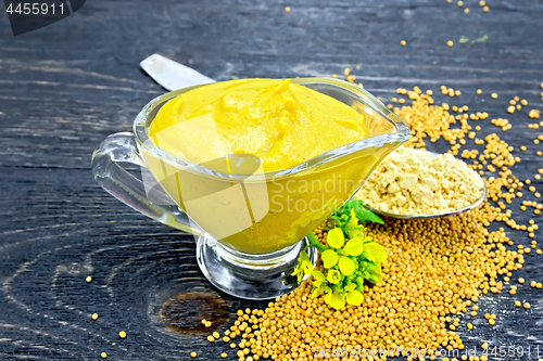 Image of Sauce mustard in sauceboat with powder and flower on board