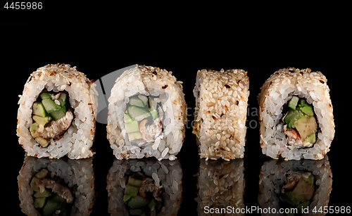 Image of Several sushi california rolls in a row