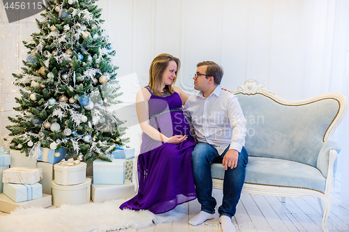 Image of Family portrait near christmas tree