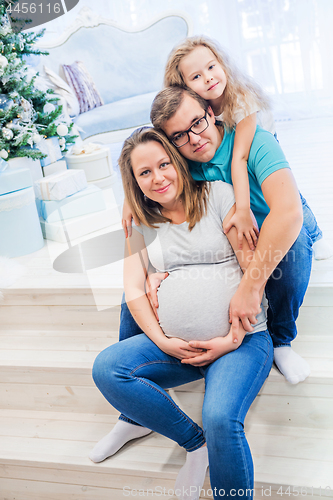 Image of Family portrait near christmas tree