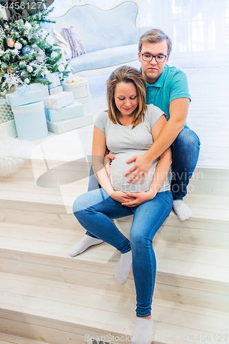 Image of Family portrait near christmas tree