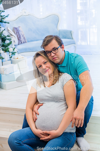 Image of Family portrait near christmas tree