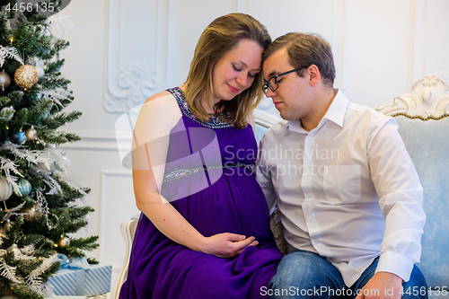 Image of Family portrait near christmas tree