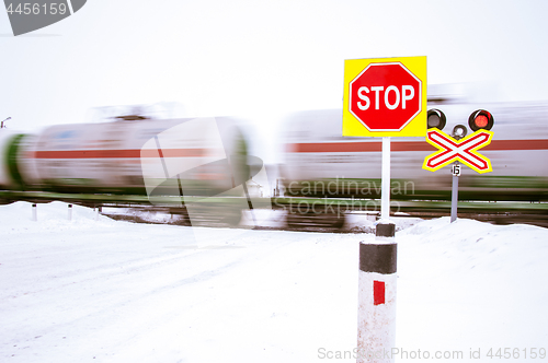 Image of A stop sign at a railroad crossing.