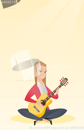 Image of Woman playing the acoustic guitar.