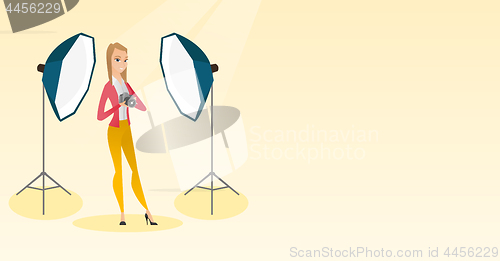 Image of Photographer with a camera in a photo studio.