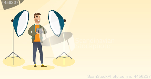 Image of Photographer with a camera in a photo studio.