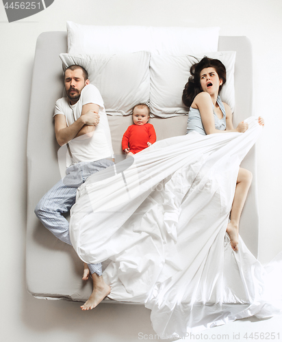 Image of Top view of happy family with one newborn child in bedroom.