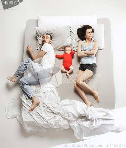 Image of Top view of happy family with one newborn child in bedroom.