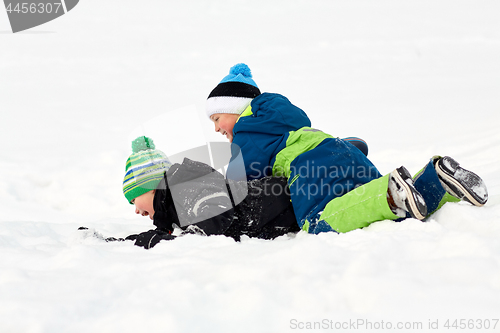 Image of happy little boys playing outdoors in winter